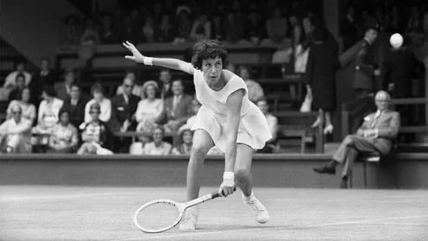 Tennis player returning a serve on court