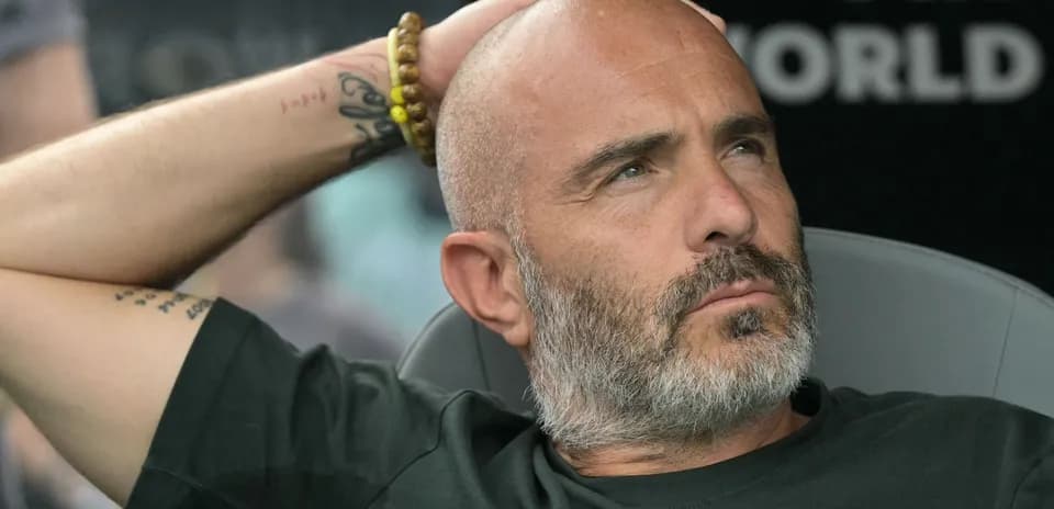 Bald man with beard resting on bench