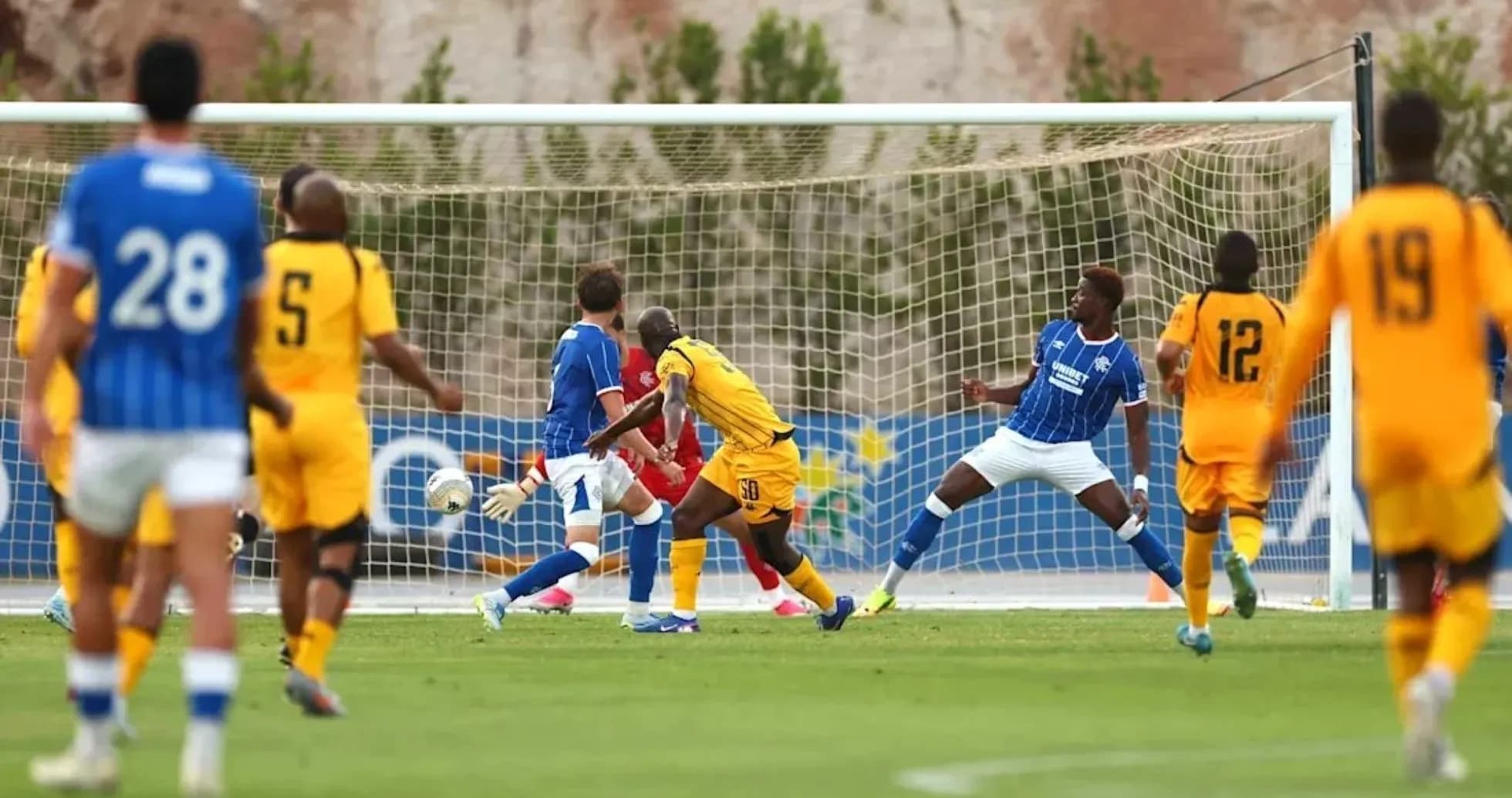 Football players contesting near the goal during match
