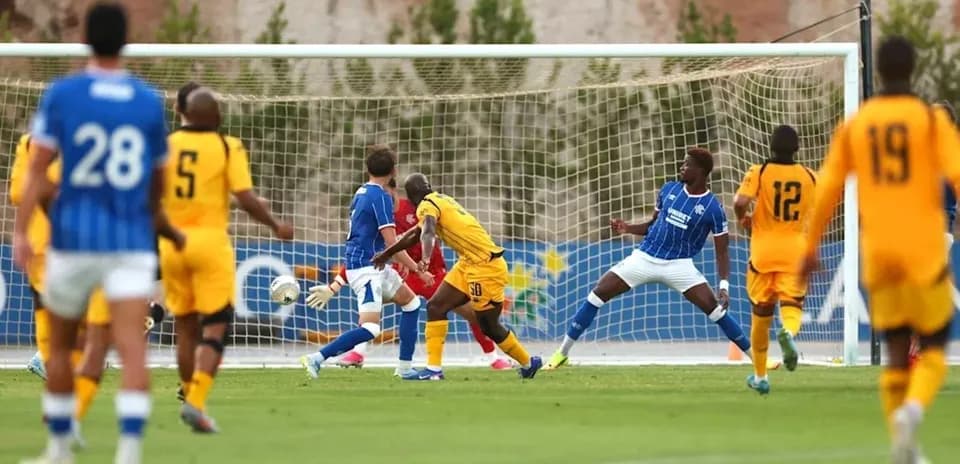 Football players contesting near the goal during match