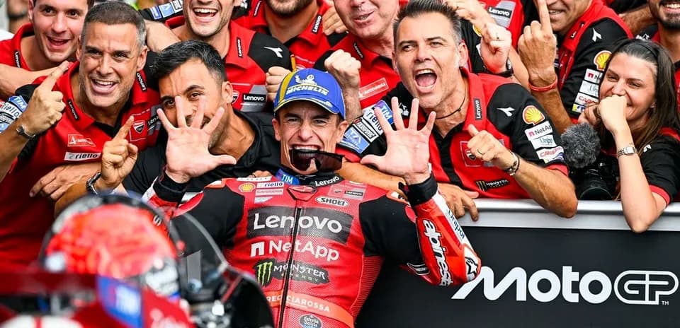 Ducati team celebrating victory with rider at event