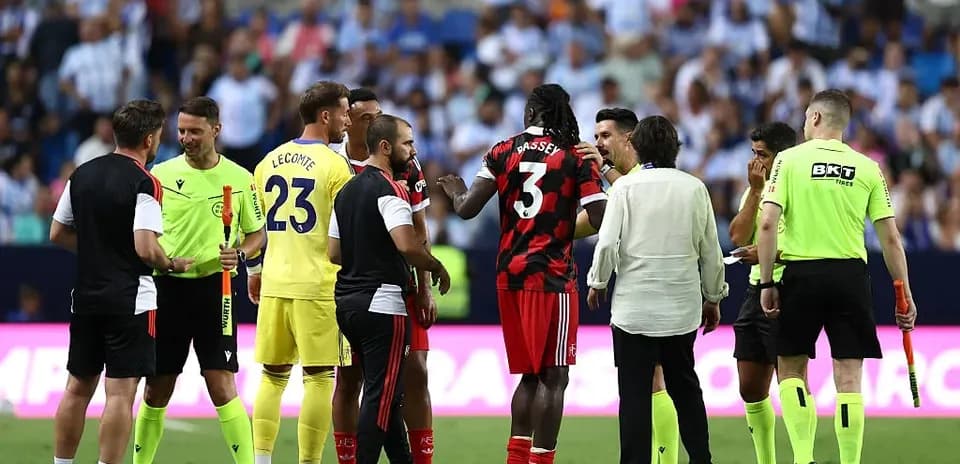 Players and officials discussing during match stoppage