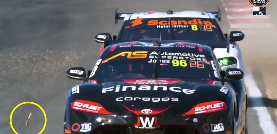 Two race cars competing with debris on track