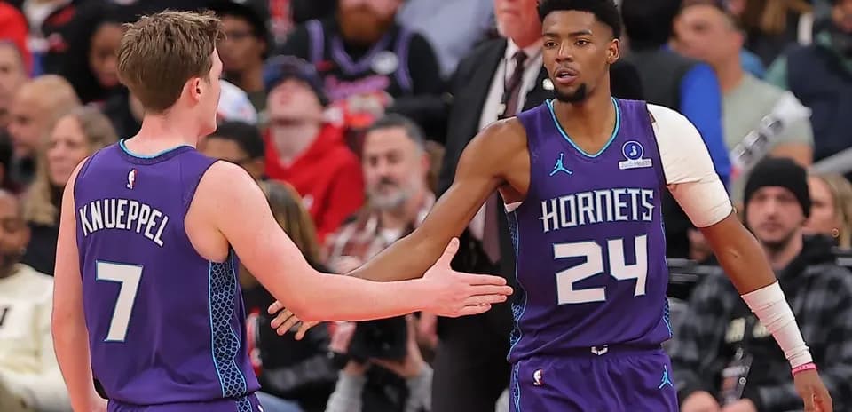 Two Hornets players celebrating during a game