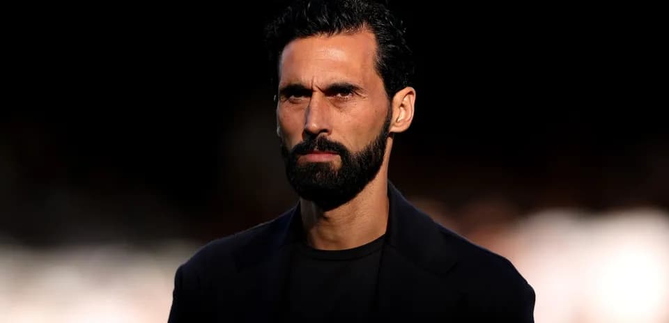Man with beard and serious expression in dark setting