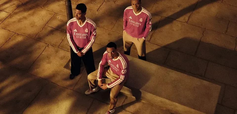 Three players posing in Real Madrid jerseys