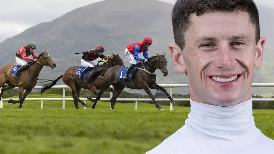 Jockeys racing horses on track with mountains behind