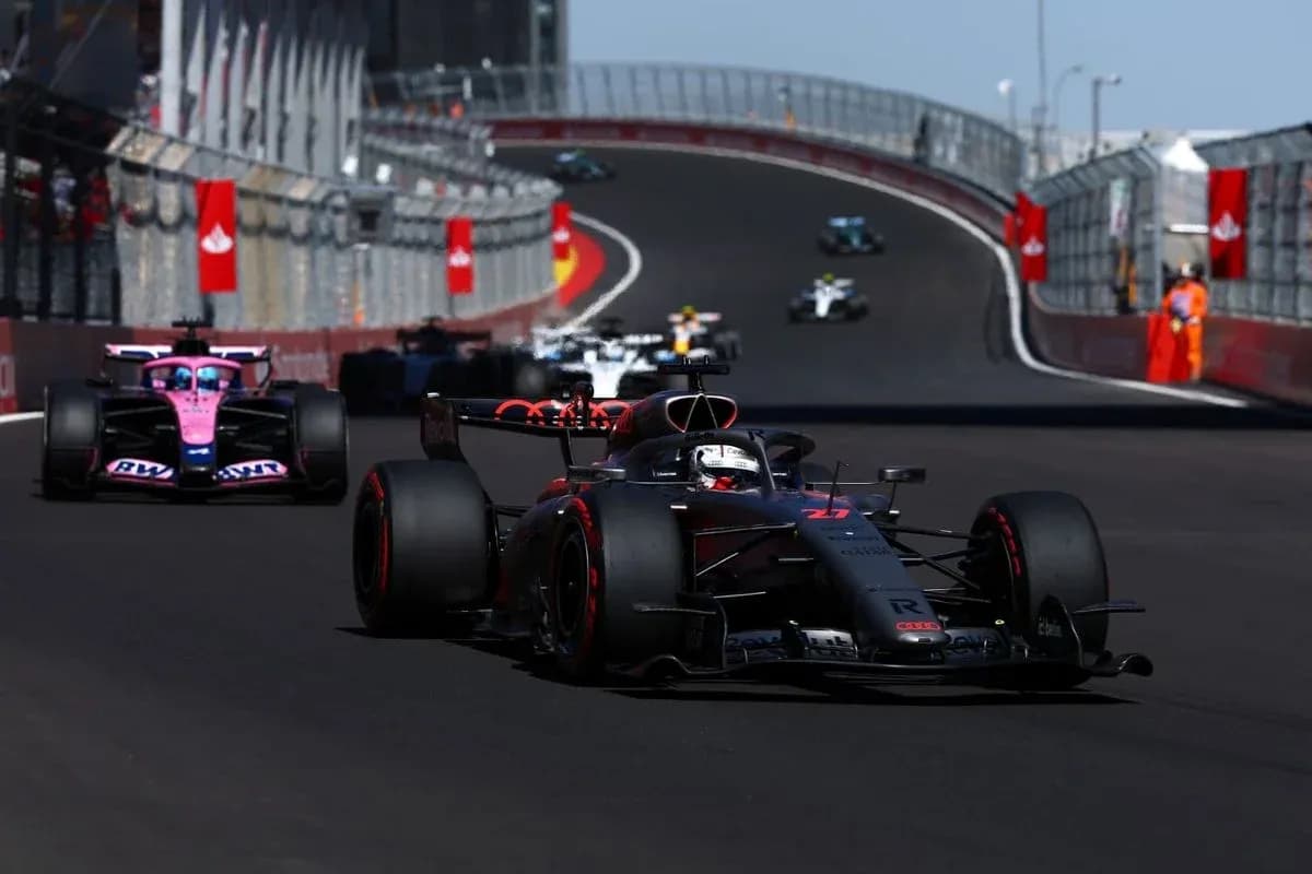 Formula 1 cars racing on a circuit track
