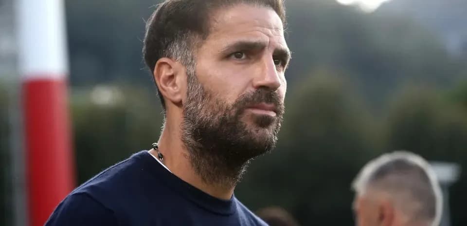 Football coach observing training session on field