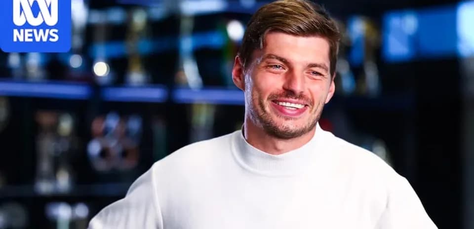 Athlete smiling during interview with trophies behind