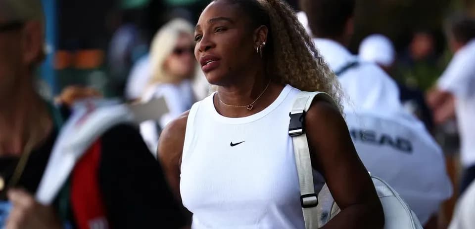 Tennis player walking with bag at event
