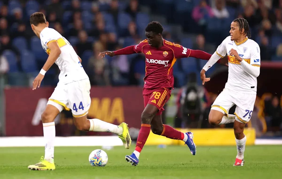 Roma player dribbling past two defenders during match