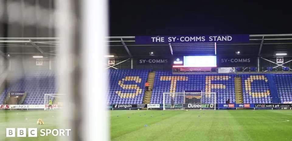 Shrewsbury Town stadium with empty stands and goal
