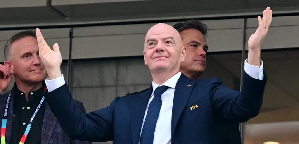 FIFA president gesturing in stadium box during event