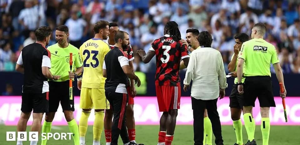 Players and officials discussing on the pitch