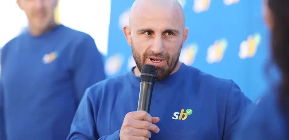 Man speaking into microphone at event