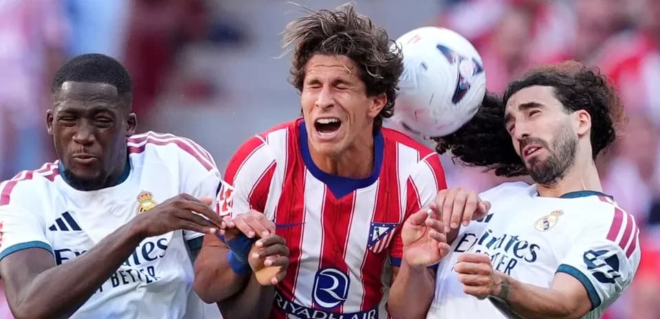 Three players competing for the ball during match