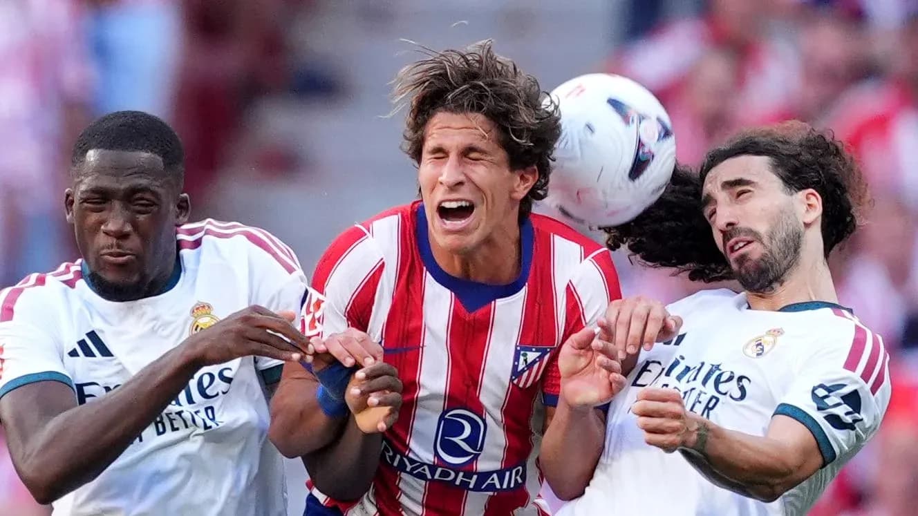 Three players competing for the ball during match
