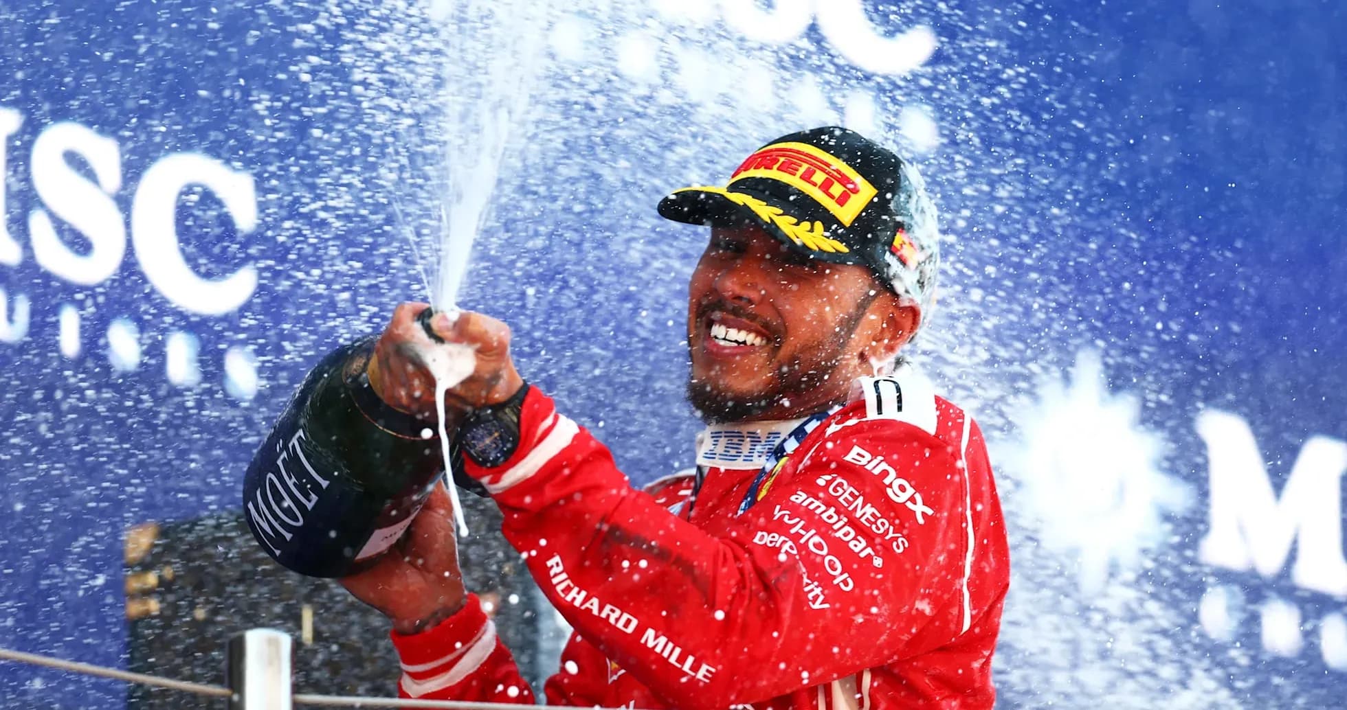 Driver celebrating with champagne on podium