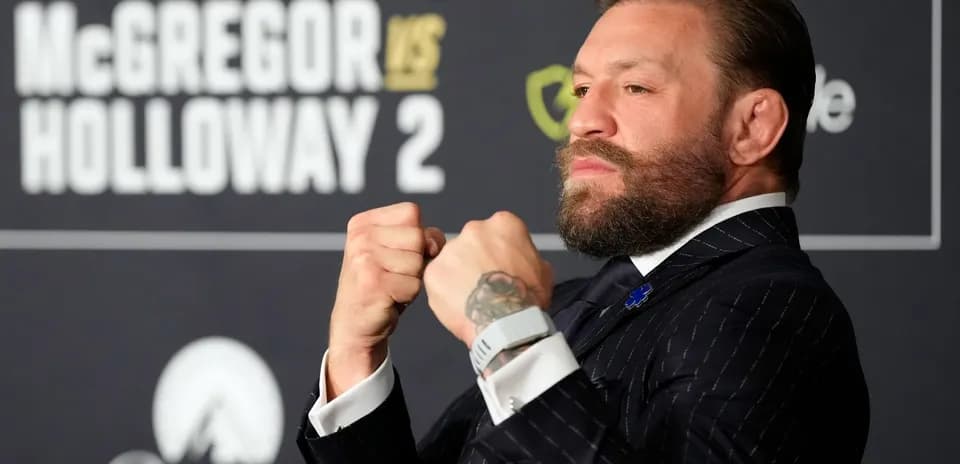 Conor McGregor posing with clenched fists at event