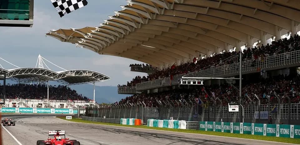 F1 car crossing finish line with checkered flag