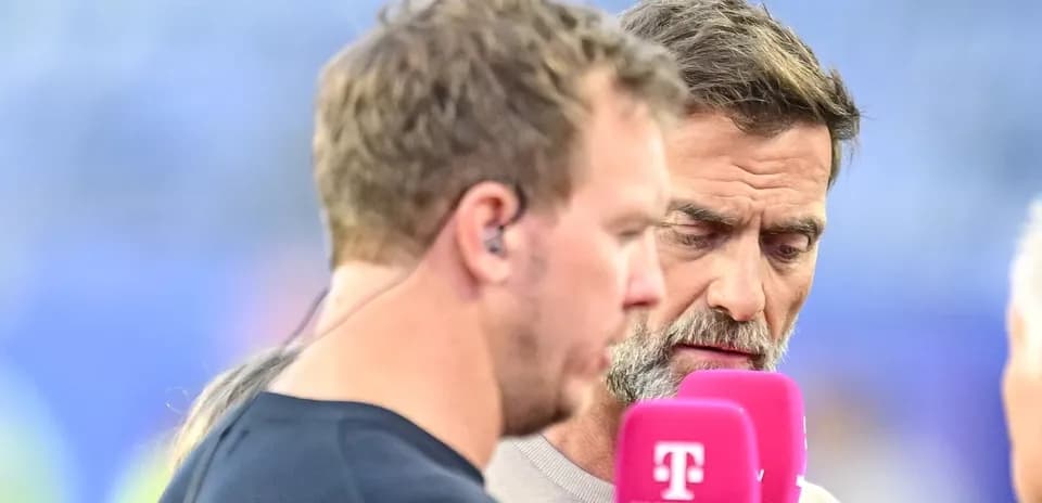 Two men speaking into microphones during interview