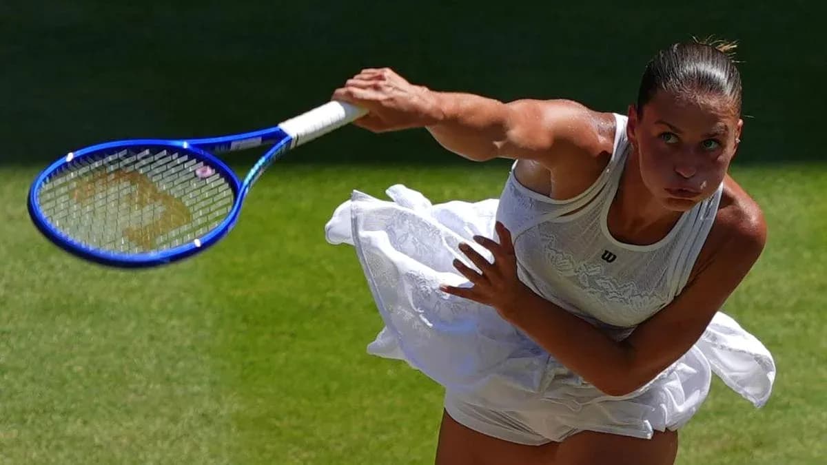 Tennis player serving on grass court
