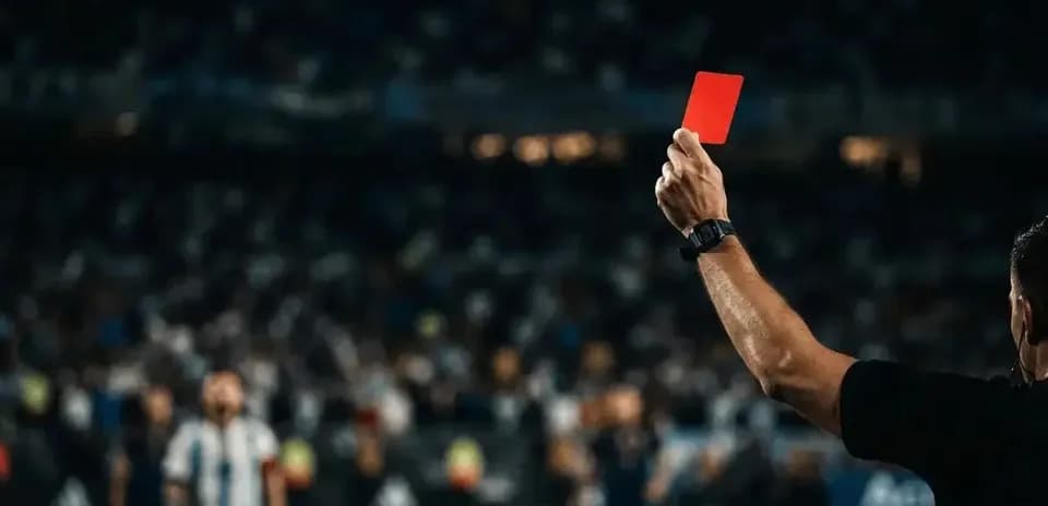 Referee showing red card during football match