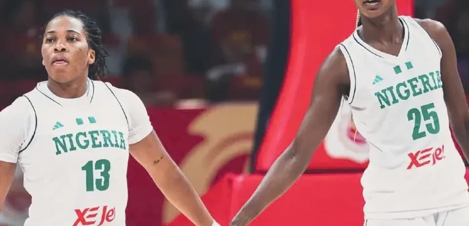 Two Nigerian basketball players holding hands during game