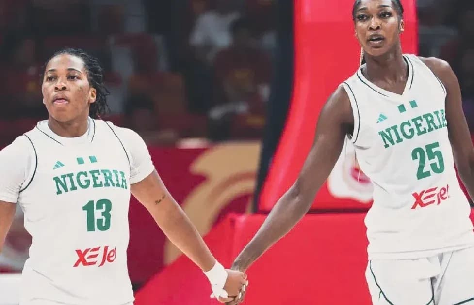 Two Nigerian basketball players holding hands during game