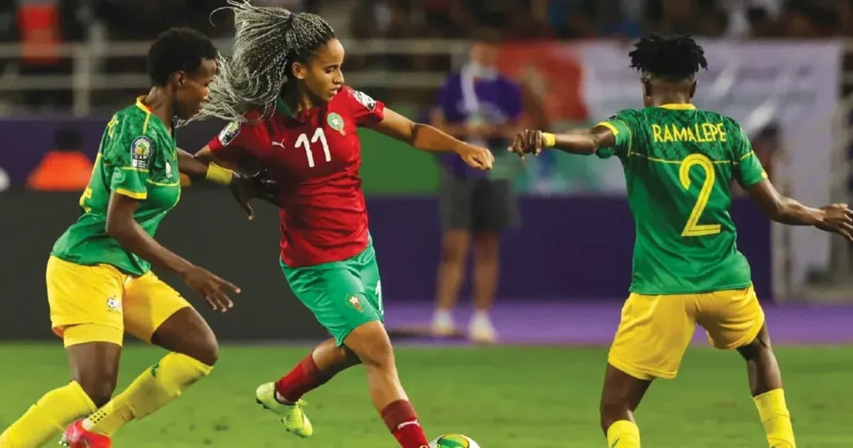 Moroccan player dribbling past two opponents during match