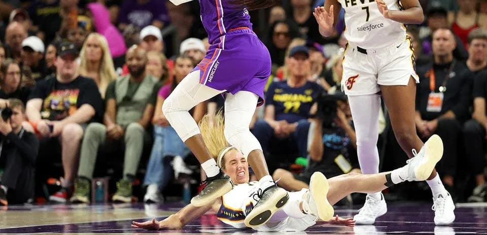 Player on the floor while another jumps over