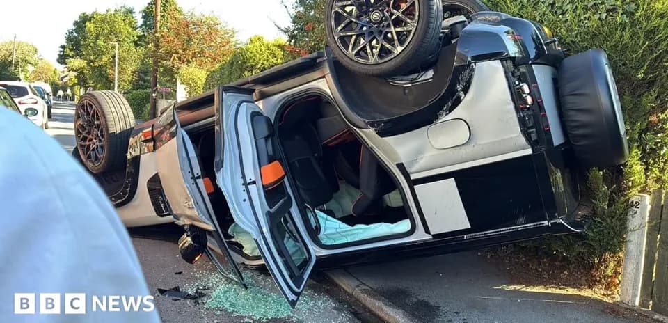 Upside down car on the side of the road