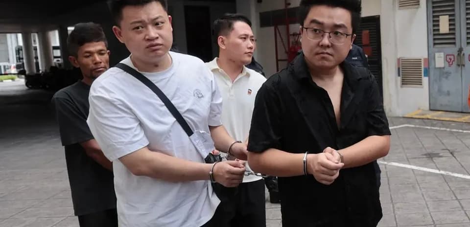 Detainees being escorted out of a building