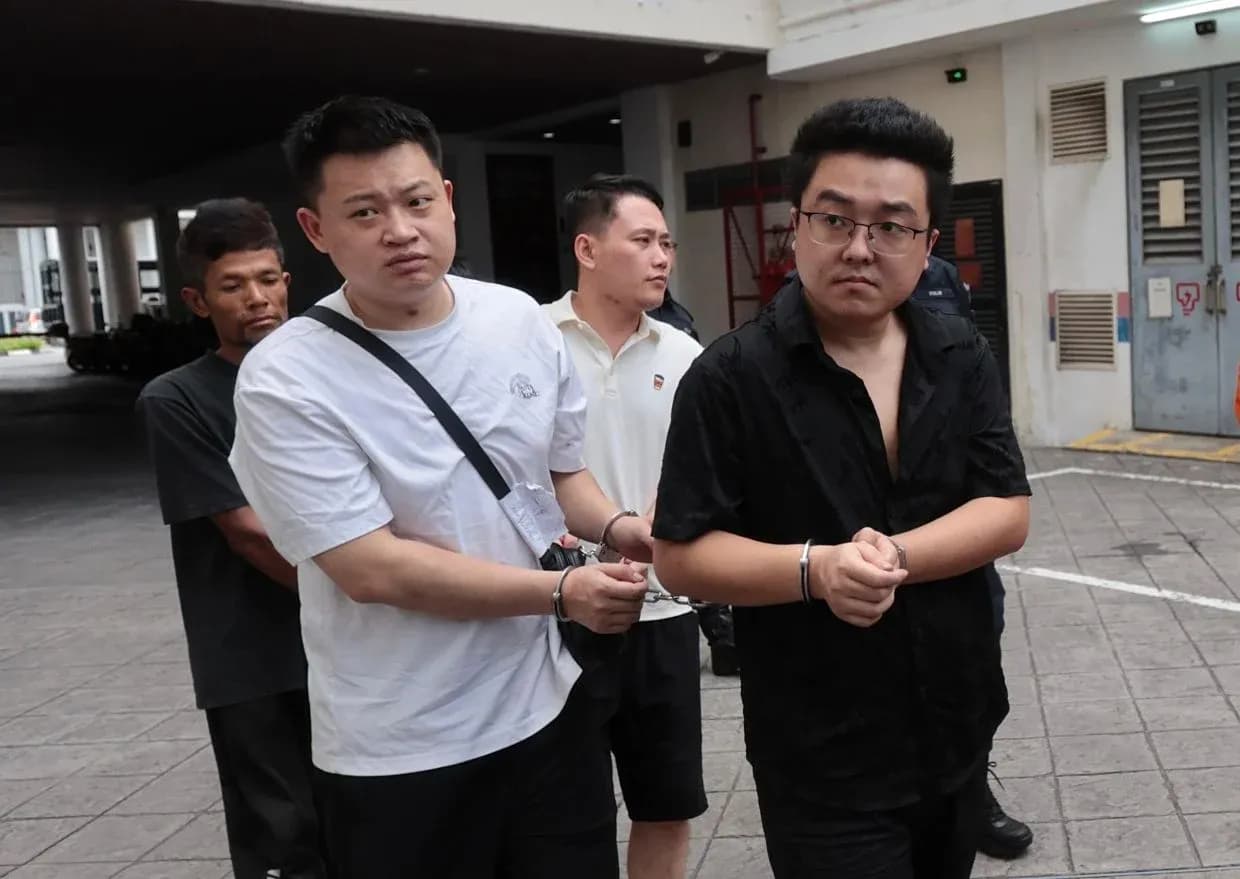 Detainees being escorted out of a building