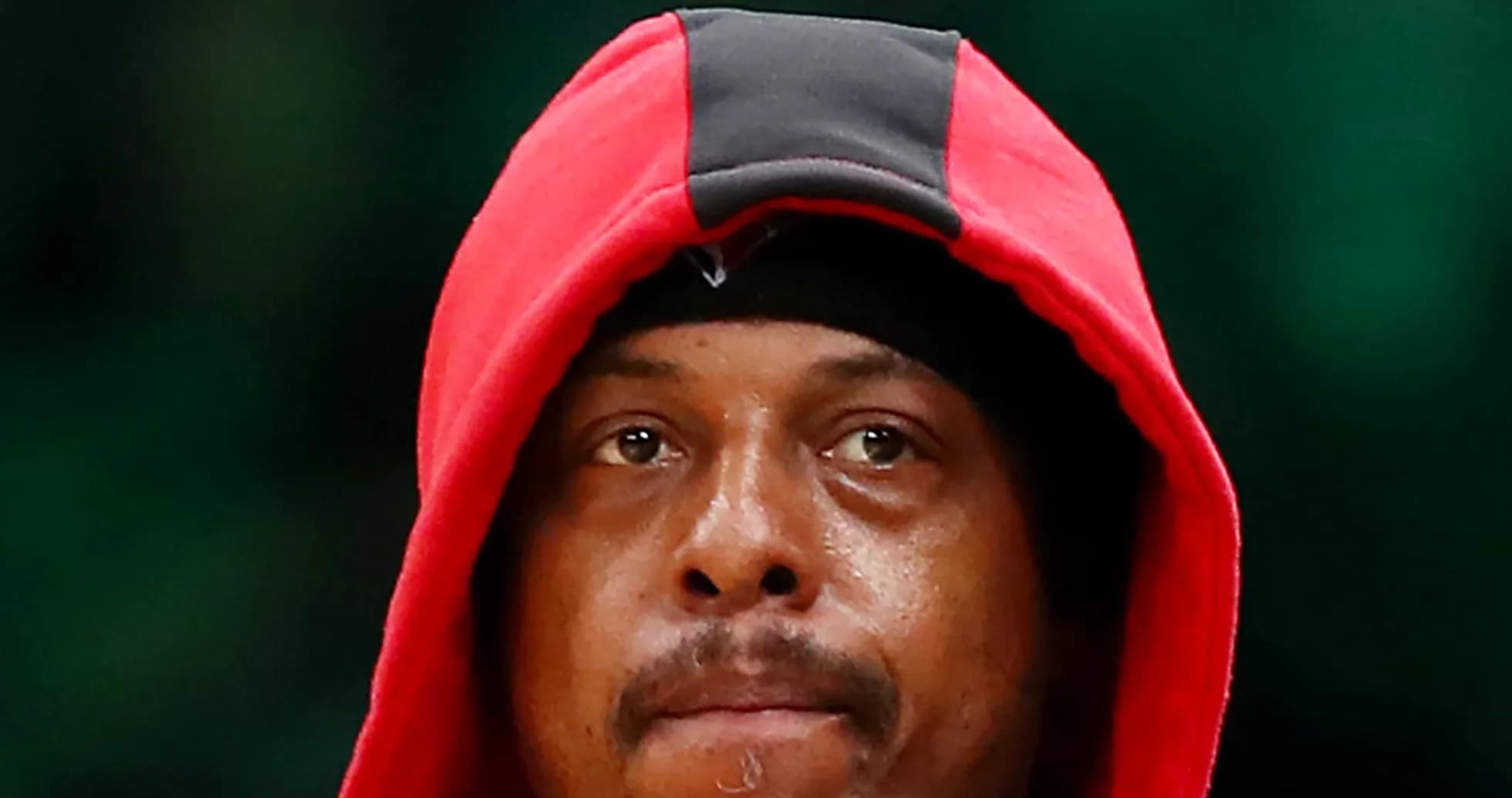 Basketball player wearing a red hoodie, focused