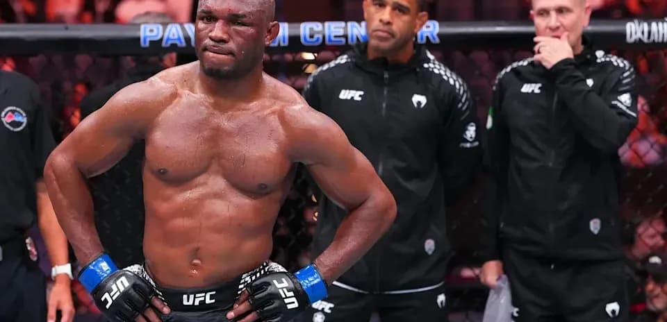 MMA fighter in the octagon with coaches behind
