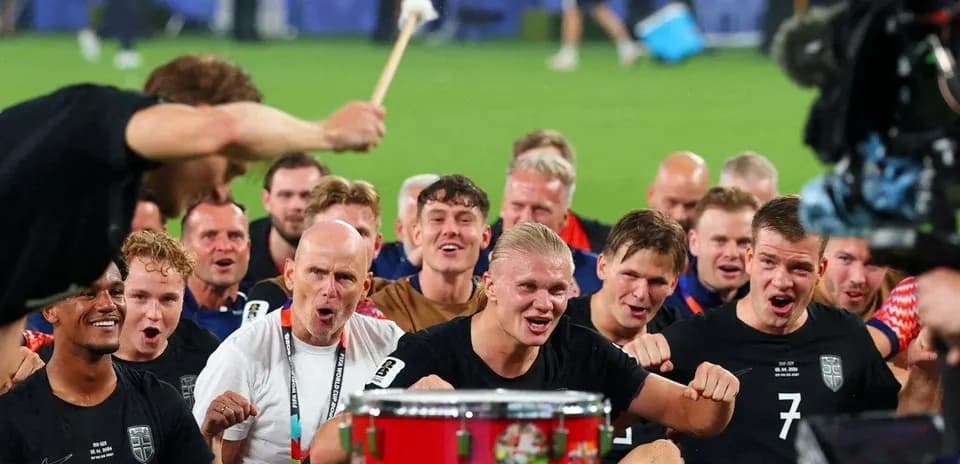 Football team celebrating with drum after match