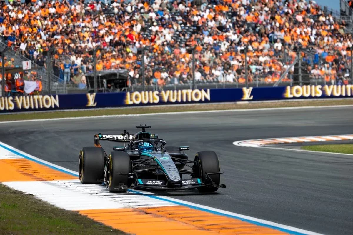 Formula 1 car racing on track with spectators in background