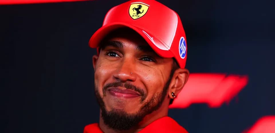 Formula 1 driver wearing Ferrari cap during event