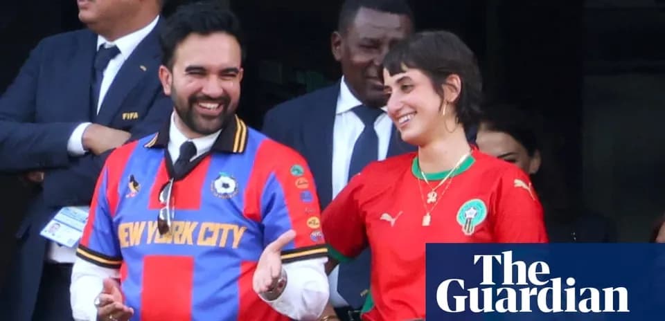 Two fans wearing team jerseys smiling together