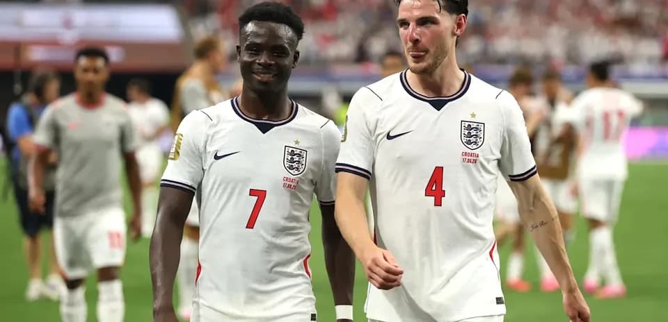 Two England players walking off the pitch together