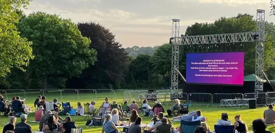 People watching outdoor movie screening in park