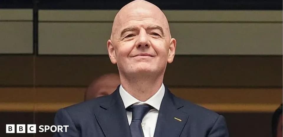 Person smiling in a formal suit at event