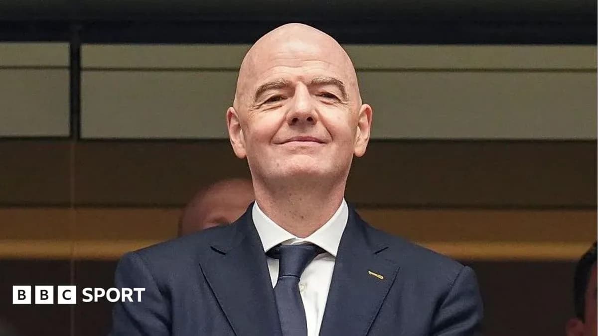 Person smiling in a formal suit at event