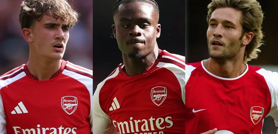 Three Arsenal players in team jerseys during match