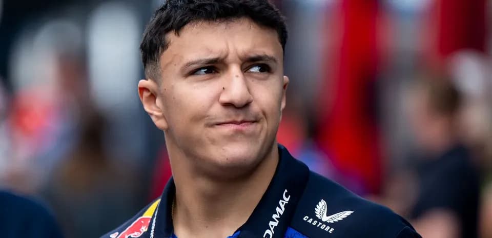 Young driver in team uniform at racing event