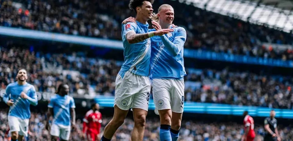 Manchester City players celebrating a goal in stadium