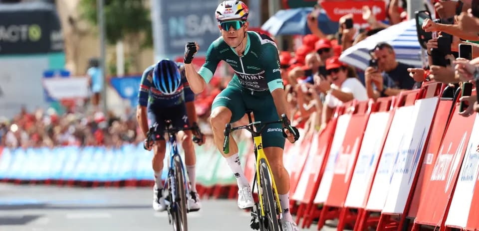 Bicycle racer celebrating victory at finish line