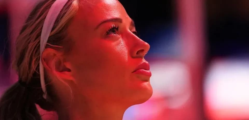 Athlete looking up in arena lighting